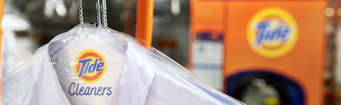 Tide Cleaners close up of a shirt hanging with a Tide Cleaners branded hanger showing.