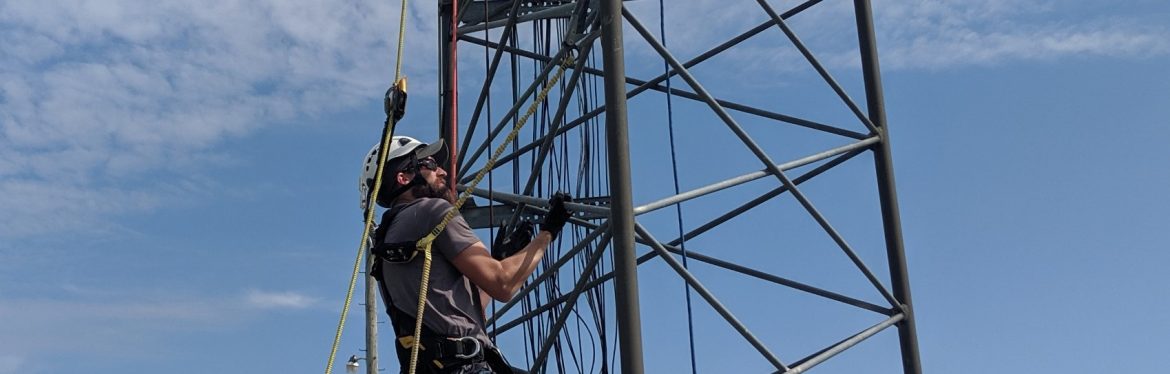 New Lisbon Telephone Company. Man climbing a tower for certification