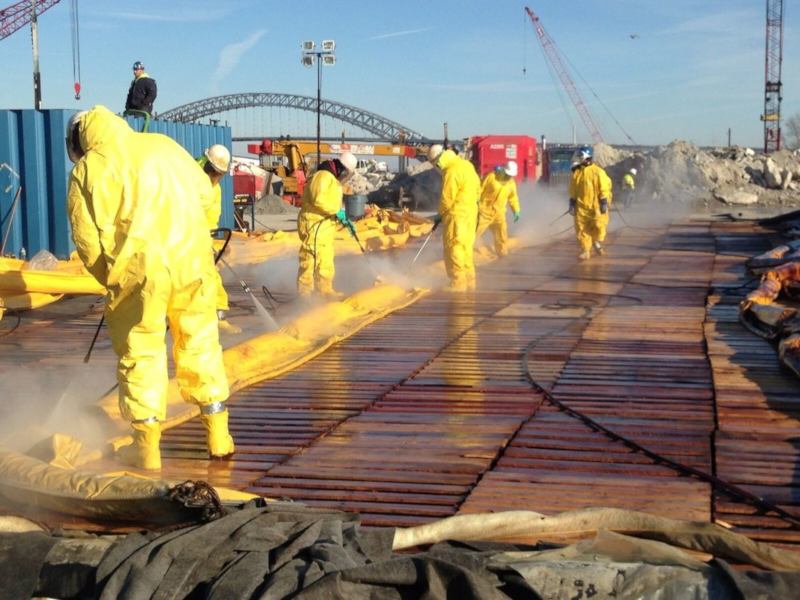 Progressive Pipeline Management men at work in environmental suits.