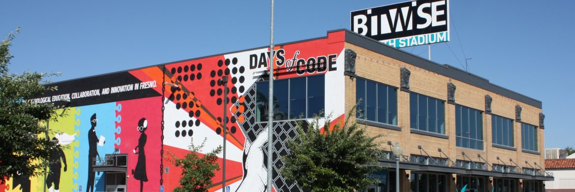 Fresno, California colorful building art on facing wall and Bitwise Stadium billboard behind