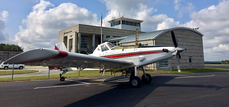 The Heart of Georgia Regional Airport is located three miles east of the City of Eastman in South Central Georgia, and services general aviation air traffic from all over the southeast United States. The Airport was originally built by the State of Georgia for the Stuckey’s Corporation to support its business operations. “Mr. W.S. Stuckey, who started the candy company here in Eastman, Georgia, selling pecan log rolls by the side of the road, kept expanding and started putting stores all up and down the Interstate,” explains Airport Manager, Jeff Fordham. “They had a Piper Aztec, and their airstrip was not long enough, so they came out here and built the Airport because they needed a place to land their bigger planes.” When the facility was officially dedicated in December 1966, then Governor Carl Sanders hailed the $232,000 Eastman-Dodge County Airport as “the first community airport in Georgia that we have built specifically to accommodate the modern business jet airplanes that are becoming so important in one industry after another.” Today, the Heart of Georgia Regional Airport is owned and operated by Heart of Georgia Regional Airport Authority and is overseen by a seven-member Board of Directors, made up of two members from the Eastman City Council, two members from the Dodge County Board Commissioners Office – one is a sitting board member from each of those, and one is an at-large appointment - and two members from the Dodge County-Eastman Development Authority – one is a board member, one is an at-large appointment. The seventh member is appointed by the Georgia House of Representatives. The Airport’s original 4,500-ft. runway was lengthened to 6,506 feet in 2004, and equipped with a precision instrument landing system and a landing capacity of 100,000 pounds. A new terminal and tower were completed in 2005. The Airport supports between 300-400 operations per day, comprised of general aviation, corporate, military, flight training, customs and border patrol, air ambulance, and aerial agricultural traffic, making it the 5th busiest take-off and landing airport in the state. Over the last several years, the Heart of Georgia Regional Airport has also become a major aviation education presence in the Southeast. It is home to Middle Georgia State University’s Aviation Center – Georgia’s only state-supported aviation center – which trains pilots and airport and airline management majors, while giving airframe and power plant students the skills required to build and maintain aviation assets. The school’s flight program is FAA-approved, and its campus at the Airport is home to a fleet of 30 airplanes, four helicopters, and several advanced simulators used in training and instruction. In 2007, the school’s Air Traffic Control Management program was named the top new ATC program in the nation by the FAA. The Airport is also home to several aviation manufacturing and maintenance firms. Fordham Aviation Inc. provides aircraft maintenance services; KENCOA Aerospace LLC is a premier Tier-1 supplier of multi-axis precision machined and sheet metal fabricated aerostructures, jet engine components, and major assemblies for commercial, military, and business/regional jets, worldwide; AREMAC Heat Treating East, LLC, is a nationally recognized heat treatment company; and Valence Surface Technologies is a full-service metal finishing company for the aerospace industry. Machining, heat treatment, and finish coating, located next door to each other on the same airport – a unique capacity that isn’t repeated anywhere in the country – means a much faster turnaround for parts manufacturing and final delivery to companies such as Boeing, Airbus, Lockheed-Martin, Gulfstream, and Sikorsky. All of this activity means that the Heart of Georgia Regional Airport plays a vital role in supporting the region with 376 jobs with an annual payroll of $14,700,000, and $37,169,000 in economic output for the local and regional economies. As airport tenancy continues to grow – there are currently around 60 private and corporate home-based aircraft on property - Fordham says that he would like to see more hangars built by private developers - as opposed to the county footing the bill. “Right now, everything is owned by the Airport and rented out. We have 18 hangars and they’re all full. There’s a lot of land on the west side of the airport; most everything has been developed on the east side. I think there’s a couple of hundred acres, at least, that’s available to develop with more to be obtained if we need it,” he notes. “We’re getting ready to do an apron re-hab project – we’re still working on the cost for that; it should be somewhere around a million dollars. We also want to put in a taxiway into an area where we can build more hangars or have ground leases so others can build hangars. I think it’s better if people build their own hangars.” Fordham says that the Airport’s 6,506-ft. runway is currently able to handle any normal traffic. “There was some talk about lengthening the runway, but we haven’t gotten that solidified yet,” he shares. “Right now, we’ve got a very good runway with two parallel taxiways and the pavement is in pretty good shape. So, I don’t foresee having any resurfacing projects within the next five years or so.” Regarding any potential competition from nearby airports, Fordham says that Heart of Georgia has lots of services available that one wouldn’t necessarily find elsewhere. “We have everything from catering, to courtesy cars, to 24-hour fuel availability for jets and pistons,” he reports. “And our normal operating hours are a little bit longer; we’re open 8-5 Monday through Saturday, and 12-5 on Sunday. And we don’t mind staying till seven or eight o’clock at night if we need to. A lot of airports, after a certain hour, you can’t get anybody; but we’re pretty much available 24/7 if anyone calls. With COVID, we had to cut back on our hours, but we try to pride ourselves on our accessibility and our customer service.”