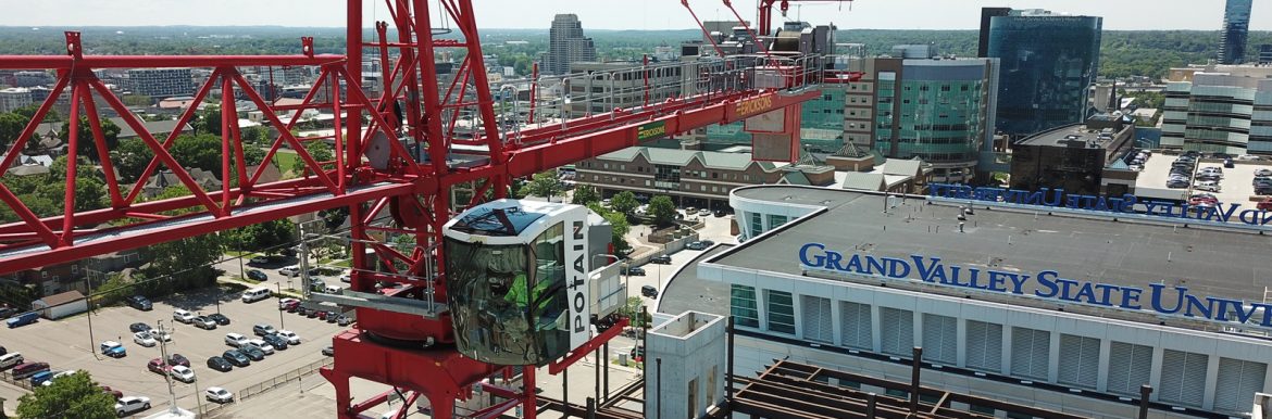 Pioneer Construction crane and steel structure going up next to the Grand Valley State University building.