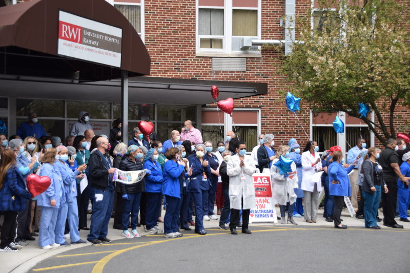 Rahway, New Jersey Rahway New JErsey University Hospital with a group of people out front wearing masks.