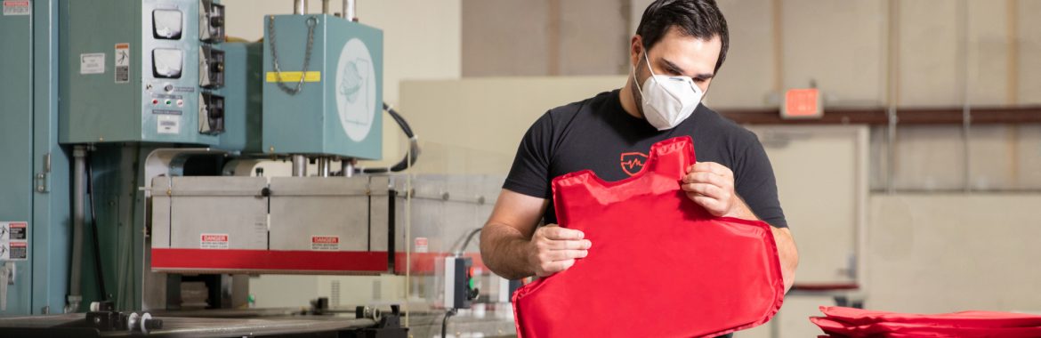 Safe Life Defense man inspecting piece of body armor